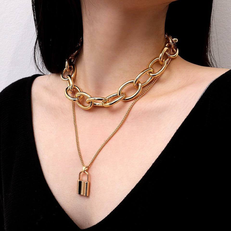 Statement chain link layered gold necklace with padlock charm. 