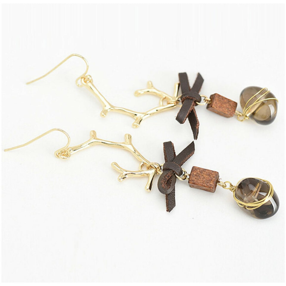 Antique gold plated, gold filled earwire with a beautiful accented leather bow, wooden box that dangles a wired wrapped brown gem (dusty quartz).